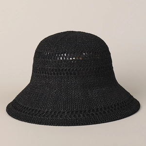 Detail of black knit sun hat featuring breathable mesh patterns and wavy brim texture