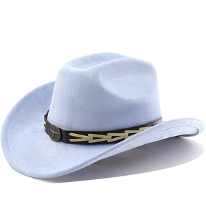 Close-up of light blue suede cowboy hat featuring vintage bull head metal emblem and strap