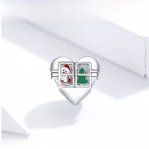 Macro detail of S925 sterling silver heart charm with Santa and Christmas tree enamel