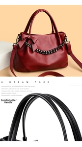 Close-up of comfortable burgundy leather handle and chain detail on the shoulder bag