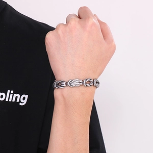 Close-up of men's stainless steel knot bracelet with vintage finish on wrist