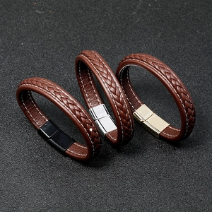 Detailed view of three braided leather bracelets with black, silver, and gold magnetic clasps