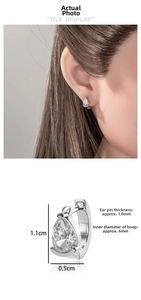 Detail view of teardrop zircon huggie earrings showing 1.1cm height and 6mm inner diameter