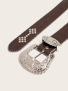 Detail of dark brown faux crocodile belt with silver western buckle and metal studs