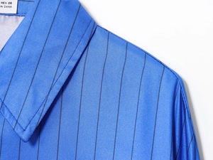 Detail of blue striped shirt collar with MEX 26 label and twill fabric texture