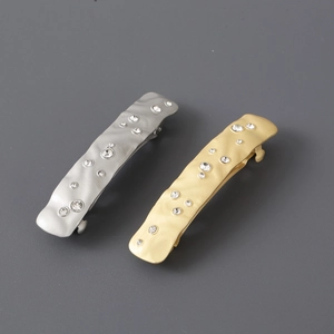 Elegant gold and silver hair clips with sparkling rhinestones in an irregular spring design