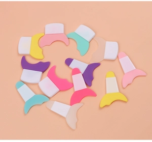 Detailed view of multi-colored silicone eyeliner stencils and mascara shields on pink base