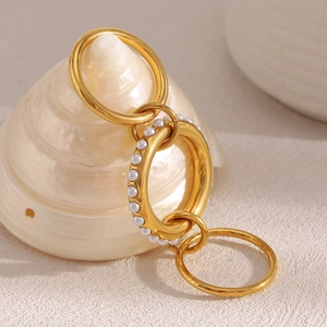 Detailed view of 18K gold plated triple-layered rings with elegant faux pearl inlay