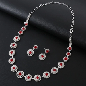 Elegant bridal silver necklace and earrings set with round red stones and rhinestones