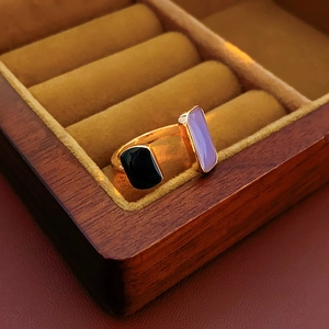 Macro detail of French vintage gold open ring with black and purple enamel inlay