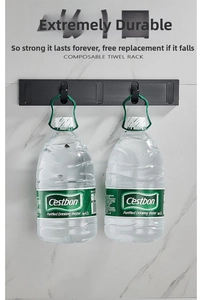 Close-up of wall-mounted black folding hooks holding two heavy water bottles for weight test