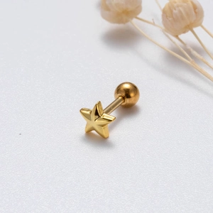 Detailed close-up of a golden star stud earring with a spherical screw back
