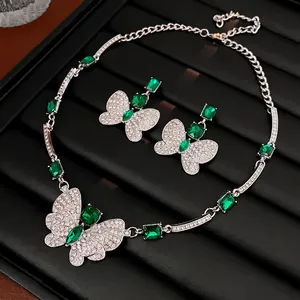 Silver butterfly jewelry set with emerald green crystals and sparkling diamonds