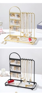 Detailed close-up of iron jewelry organizer with earring holes and necklace hooks