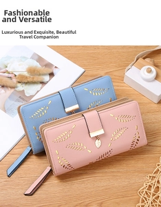 Close-up of long women's wallets in blue and pink with leaf cutout and gold charm