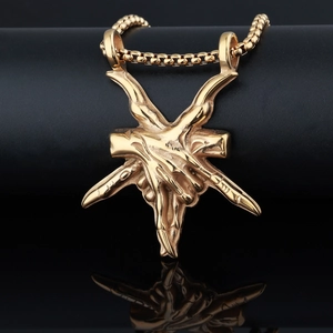 Detailed view of a golden hexagram devil hand pendant with a matching box chain and reflection