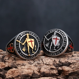 Macro view of knight shield rings with Bible verses on rustic wood background