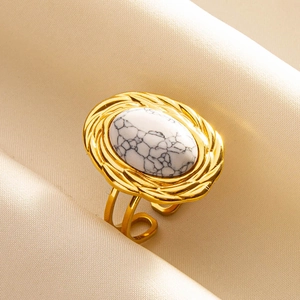 Detailed view of adjustable gold ring featuring an oval white marble stone inlay