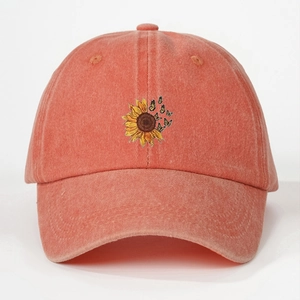 Orange washed baseball cap with embroidered sunflower and butterfly patterns
