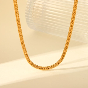 Close-up of 18K gold plated titanium steel necklace with fine woven chain texture