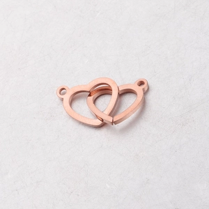 Macro shot of rose gold interlocking heart connectors for DIY jewelry making 12x20mm