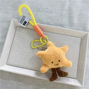Portachiavi a stella di peluche giallo con viso sorridente e gancio per borsa