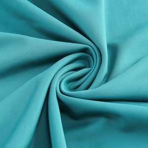 Close-up of cyan pleated fabric texture showing high elasticity and soft drape details
