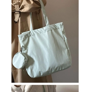 Detail of light green nylon tote bag with matching coin purse and shoulder strap
