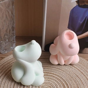 Detailed view of dog-shaped silicone molds for resin casting in pink and mint green