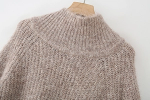 Close-up of oatmeal knit sweater showing premium fuzzy alpaca wool and ribbed neckline