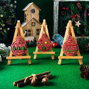 Christmas tree and star patterned cookie cutters in a festive holiday scene setup