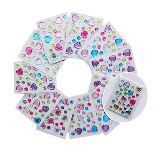 Macro shot of assorted colorful heart and round rhinestone face gems for festival makeup