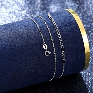 Detailed view of silver necklace chain with spring clasp and adjustable extension link