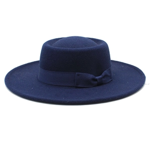 Detail of navy blue wool felt flat top hat with matching ribbon bow, British style