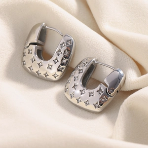 Macro shot of silver U-shaped square earrings with star pattern and micro-set zircons
