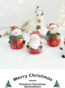 Detailed view of resin Christmas miniatures with Santa, snowman and reindeer on snow