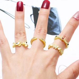 Elegant gold butterfly and flower rings set with pearls and rhinestones on hands