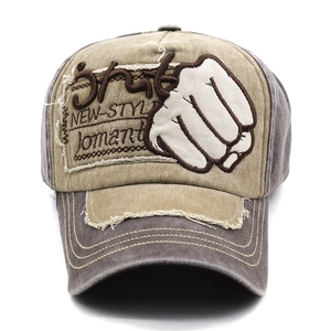 Detail of vintage washed baseball cap featuring white fist patch and embroidery