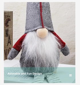 Detailed view of handmade Christmas gnome with grey hat and green striped legs