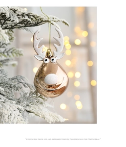 Rose gold Christmas reindeer hanging ornament with white glitter detail on snow branch