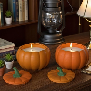 Cozy autumn setting with lit orange pumpkin-shaped candles on a rustic wooden desk