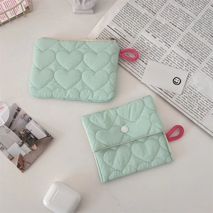 Close-up of quilted heart pattern organizers with green fabric and pink lanyard accents