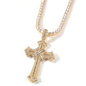 Macro shot of gold cross pendant necklace featuring intricate cubic zirconia micro-pave