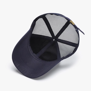 Navy blue breathable mesh trucker hat with adjustable buckle shown from an inside view