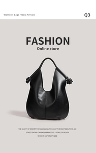 Detail of a matte black leather tote bag with unique side knot handles and vertical stitching