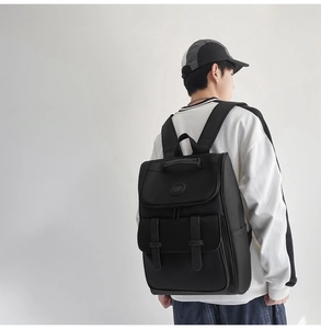 Back view of a large black casual backpack for men and women on model in minimalist style