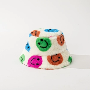 White faux fur bucket hat with vibrant colorful smiley face prints for winter warmth