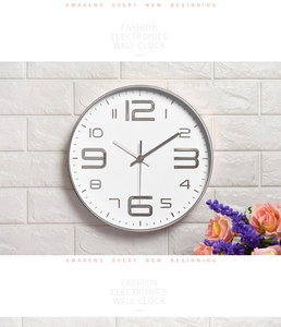 Modern 14 inch silent wall clock with silver 3D numbers on a white brick wall background