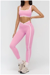 Pink yoga set with V-shaped waistband leggings and white contrast trim sports bra