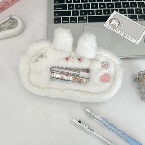 Close-up of white plush pencil case with cute bunny ears and transparent window